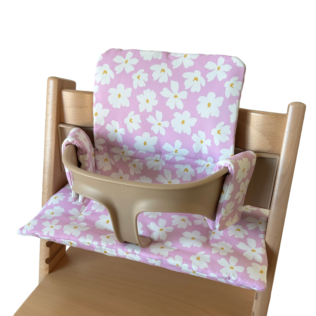 Kussenset voor Stokke Tripp Trapp met bloemenprint (roze, wit). Zijaanzicht rechts van het kussen op de stoel zonder gebruik van de babyset.