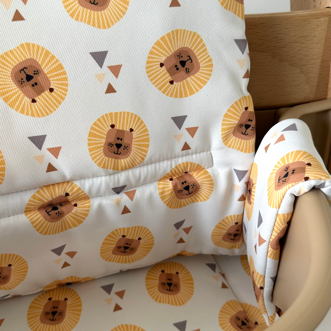 Kussenset voor Stokke Tripp Trapp met leeuwen print. Close up van het kussen op de stoel met gebruik van de babyset.